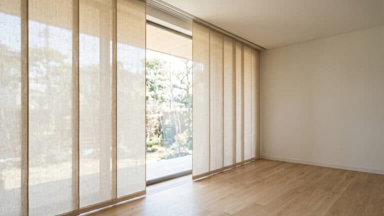 Sala de casa com painéis japoneses no lugar de cortinas